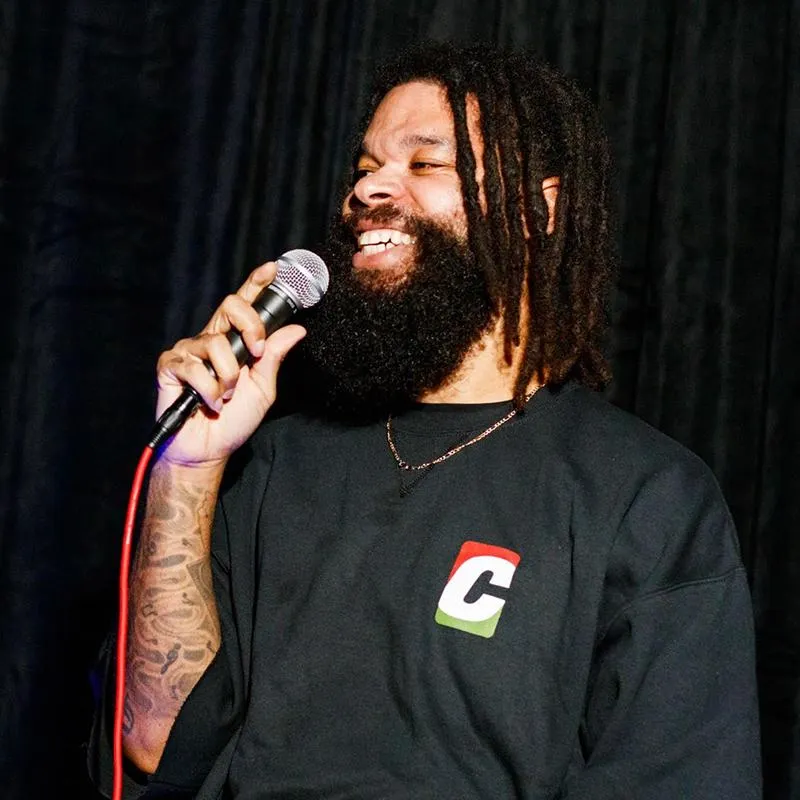 Damon Darling net worth comedian performing stand-up on stage