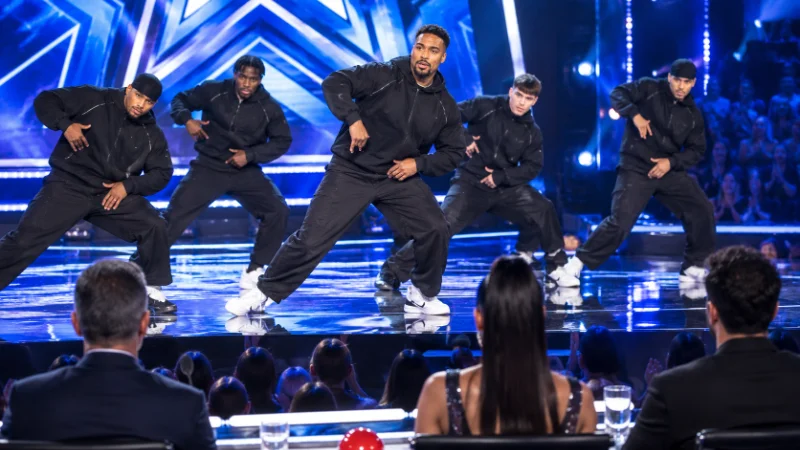 Jordan Banjo performing with his dance troupe on a talent show stage