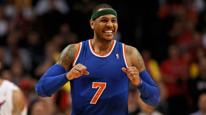 Carmelo Anthony driving to the basket in a Denver Nuggets jersey